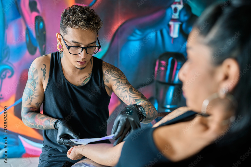 Artist tattooing a client in the studio